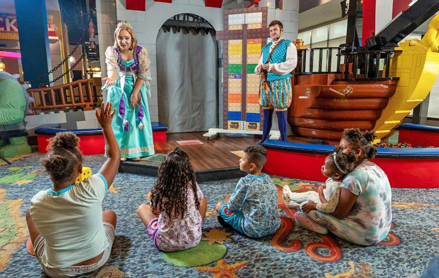 pajama wearing kids meeting characters at nightly entertainment castle play area at legoland hotel winter haven