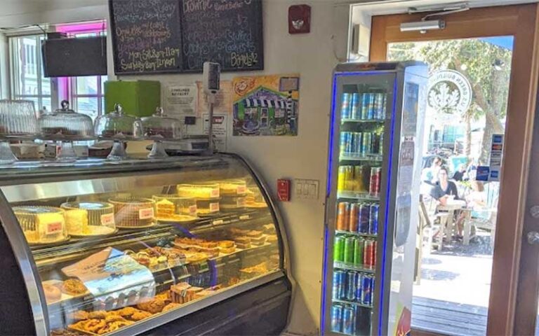 shop interior with bakery case and door at anna maria general store