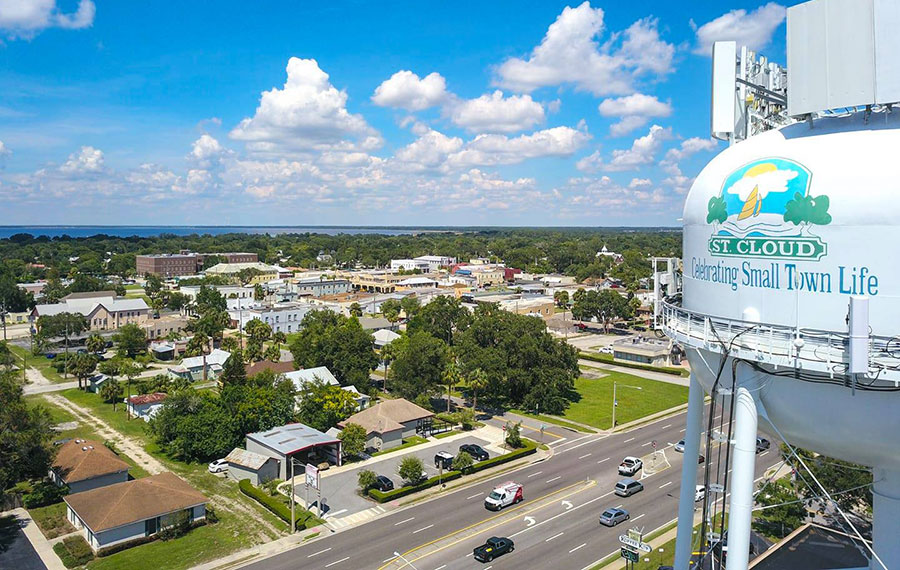 aerial of town with trees and water tower on right side at st cloud