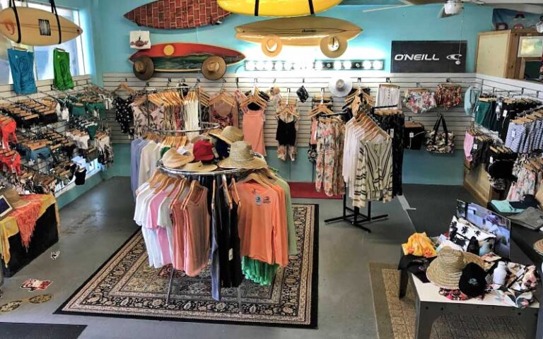 beach apparel on racks with surfboards hanging from walls at spunkys surf shop fort pierce