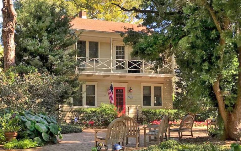 colonial style house with dense trees and patio at heathcote botanical gardens fort pierce
