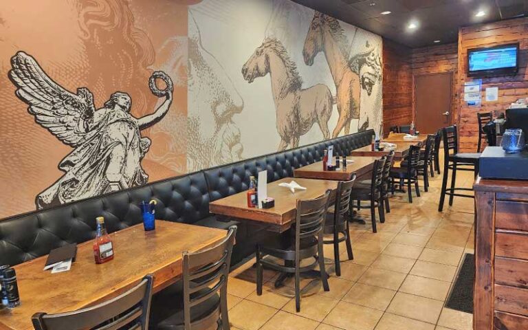diner interior with seating and wall mural at spiros taverna of st lucie west