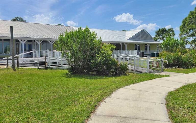 education visitor center building with porch and trees at savannas preserve state park port st lucie