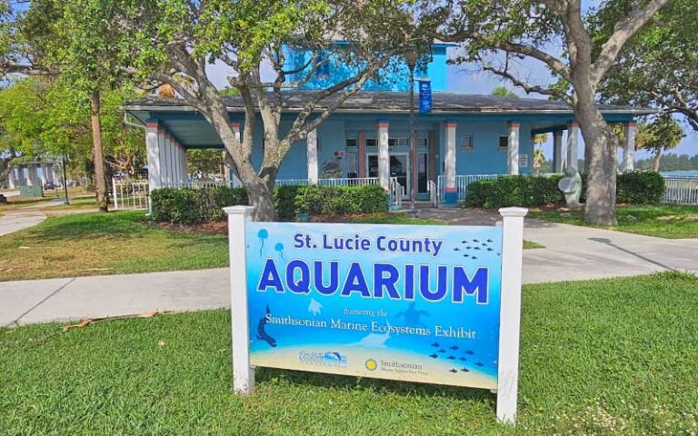 exterior of blue building in tree with yard sign at st lucie county aquarium fort pierce