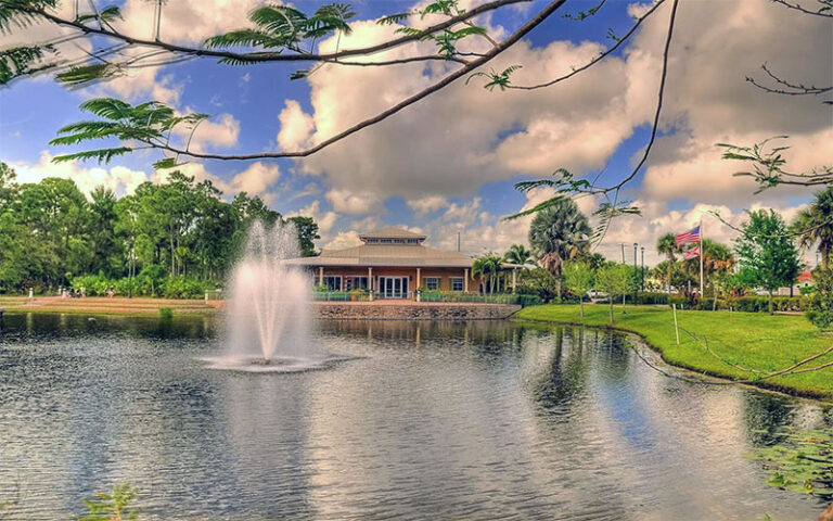 exterior view across pond with fountain at port st lucie botanical gardens
