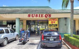 front exterior of diner in strip row with parking at susie qs port st lucie