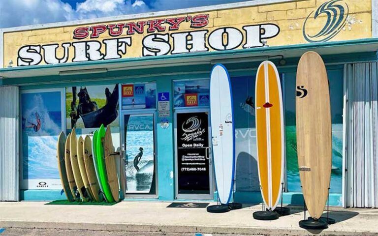 front exterior of store with surfboards propped up along sidewalk at spunkys surf shop fort pierce
