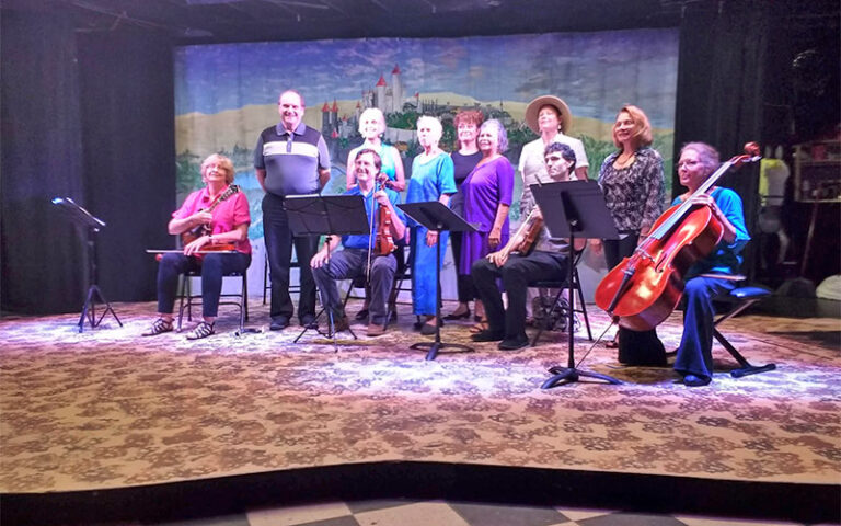 group of musicians and singers on stage at amelia musical playhouse fernandina beach