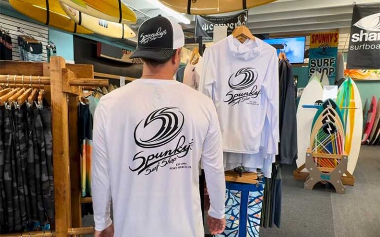 guy wearing shirt with store logo at spunkys surf shop fort pierce