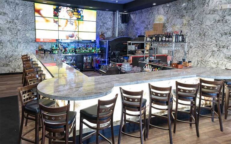 marble bar with screen and seating at tutto fresco restaurant port st lucie