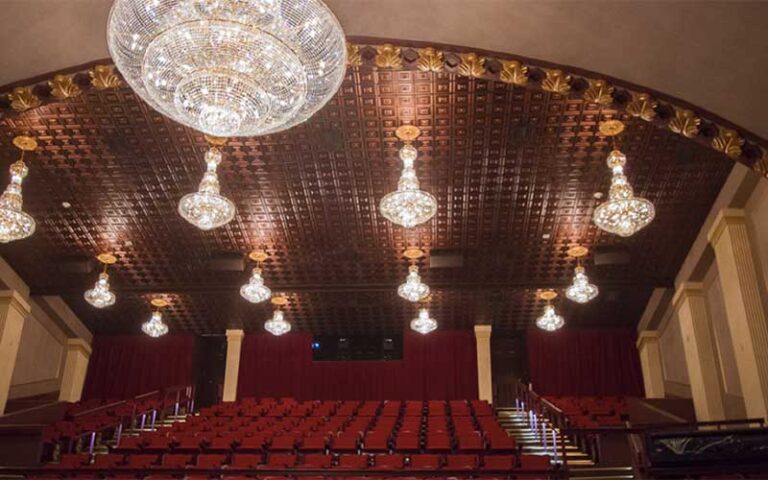 red balcony seating with chandeliers at historic cocoa village playhouse