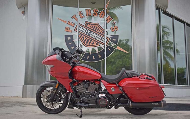 red harley motorcycle with shop window at petersons harley davidson miami