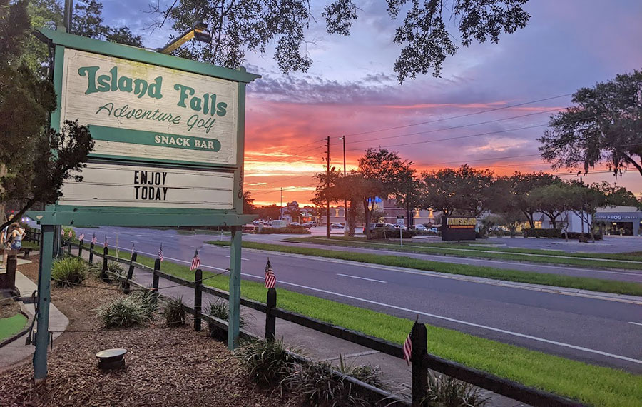 roadside sign with sunset sky at island falls adventure golf fernandina beach