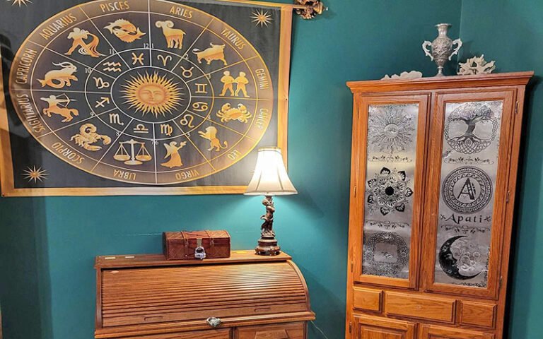 room with antique furniture and cryptic art on wall at amelia island escape rooms