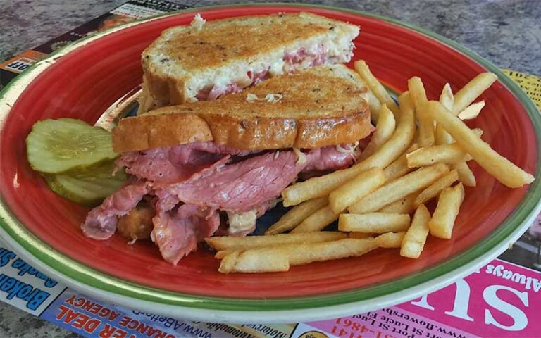 reuben sandwich with fries on red plate at susie qs port st lucie