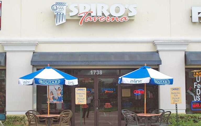 storefront of restaurant with sidewalk seating and entrance at spiros taverna of st lucie west