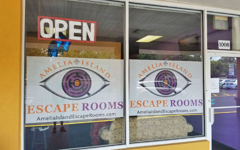 storefront with eye logo and entrance at amelia island escape rooms
