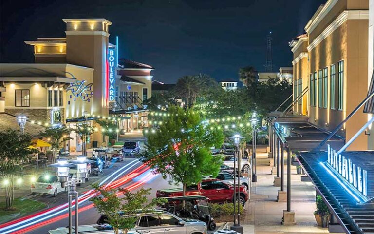 aerial night view of lighted street with shopping and theater at grand boulevard at sandestin miramar beach