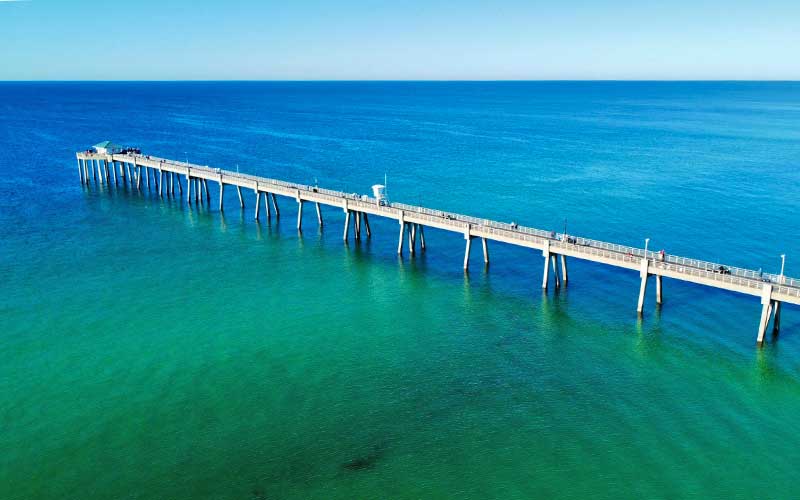 Okaloosa Island Pier extending over emerald water in the Gulf of America near Destin Florida