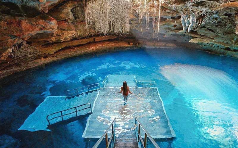 aerial view of subterranean spring cave with diving platform stairs and girl devils den williston