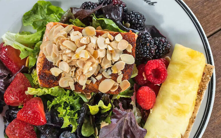 almond crusted fish fillet with fruit at the turtle club naples