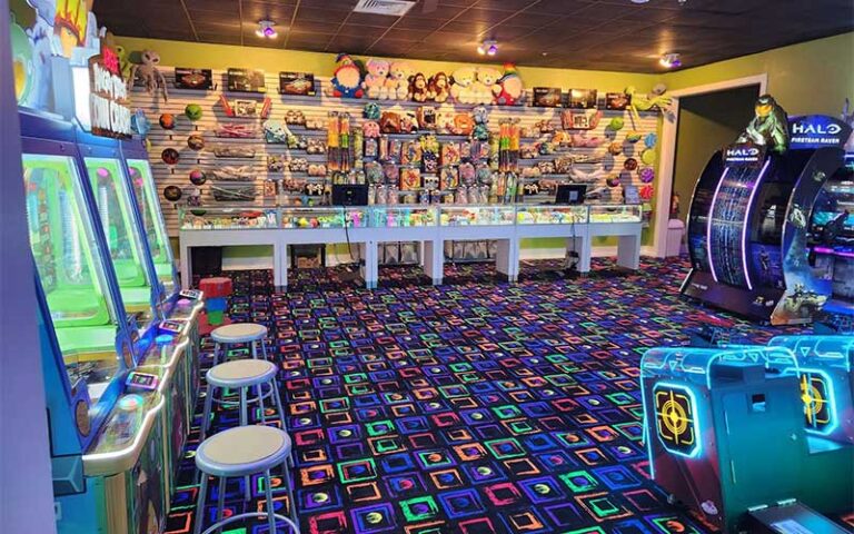 arcade room with gallery and crane games at rainforest black light golf arcade miramar beach