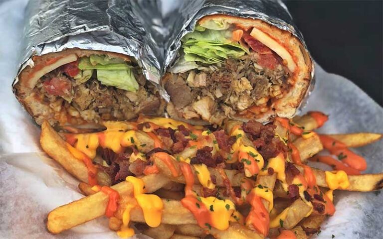 closeup of wrapped and halved mofongo with fries at the mofongo king port st lucie