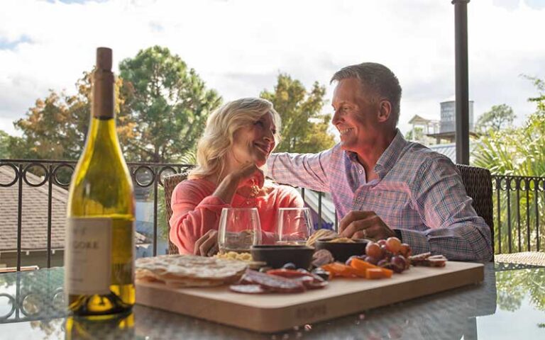 couple enjoying wine on balcony at sandestin golf beach resort miramar beach