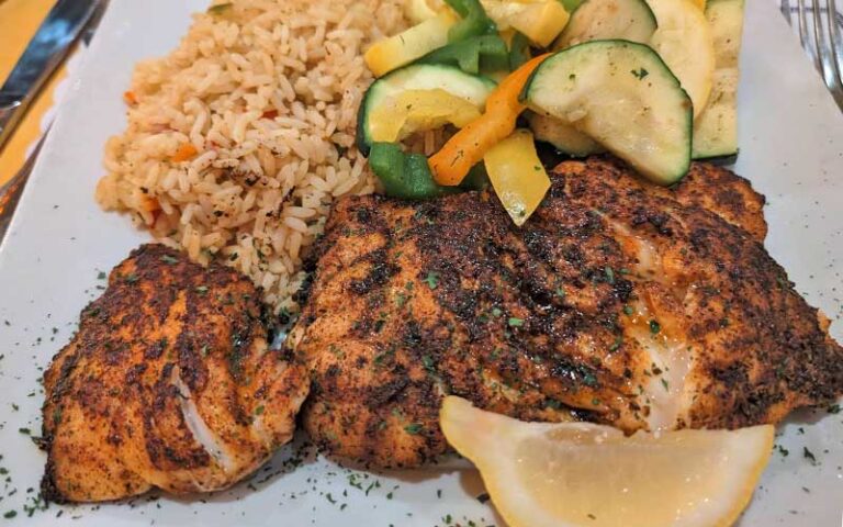 crusted fish fillets with rice and vegetables at old bay steamer fort walton beach