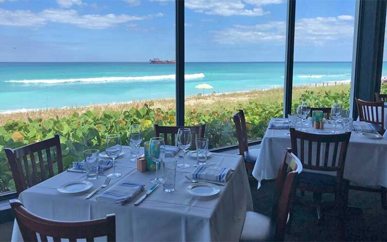 dining area with large windows overlooking beach and ship at kyle gs prime seafood steaks hutchinson island south