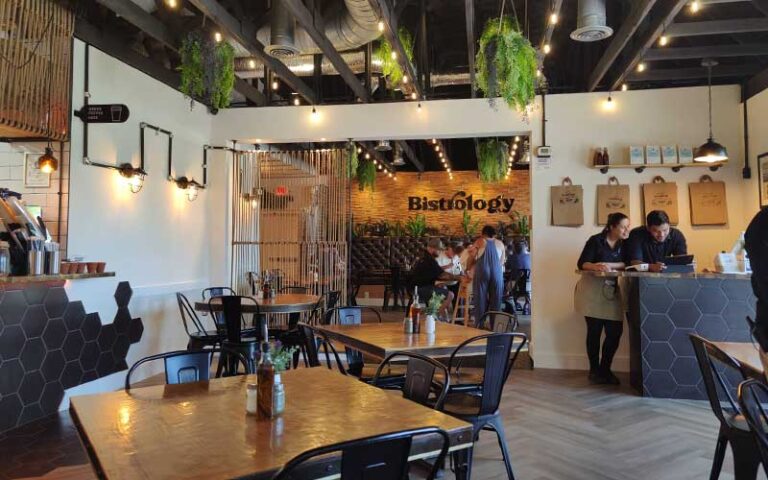 dining room area with chic decor and servers at bistrology miramar beach