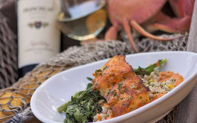 fish and spinach entree with wine at stuart boathouse
