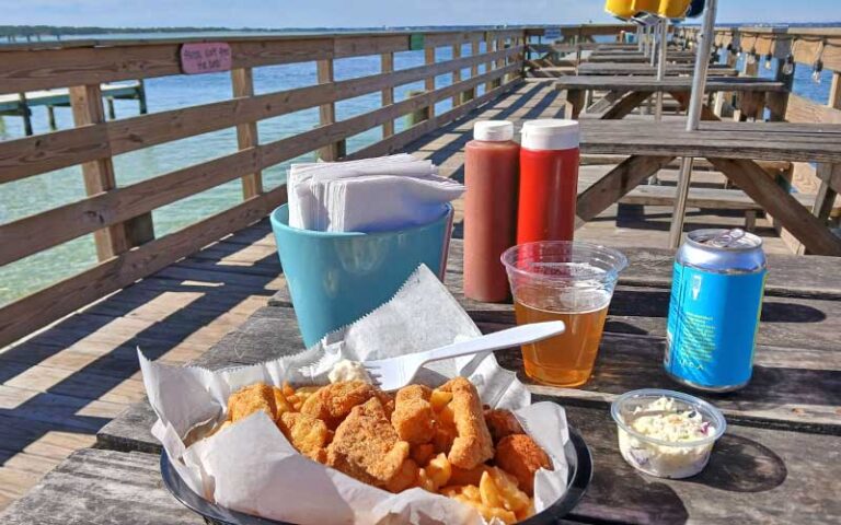 fried catfish plate with beer on pier table at dewey destins seafood restaurant