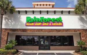 front exterior with sign and entrance at rainforest black light golf arcade miramar beach