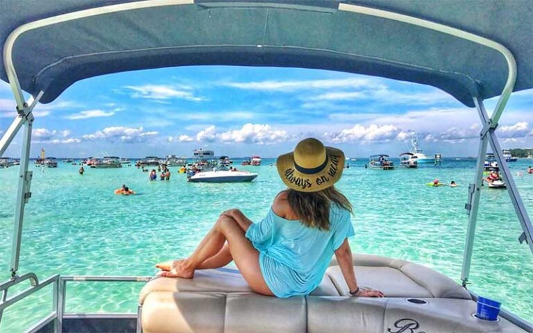girl lounging on pontoon at crab island at destiny water adventures fort walton beach