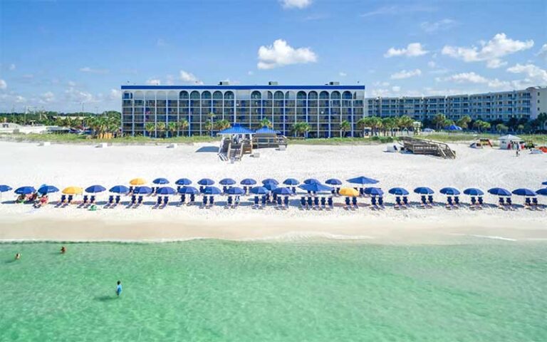 high rise hotel buildings on beach with green water at the island resort fort walton beach