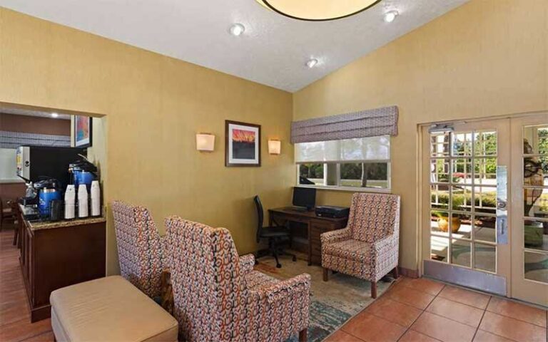 hotel lobby with chairs and coffee urn at best western port st lucie