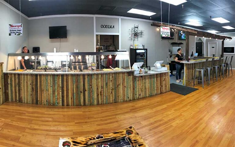 interior of restaurant with long counter at the mofongo king port st lucie