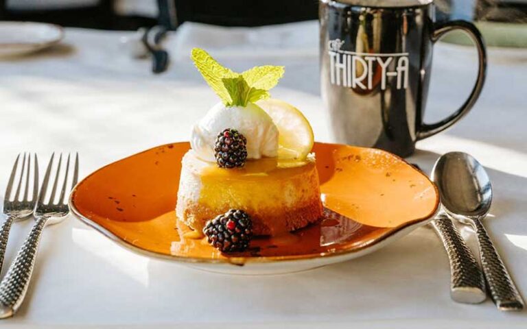 key lime cheesecake with coffee on table setting at cafe thirty a santa rosa beach