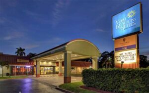 night front exterior of hotel with lighted sign at vero beach inn suites