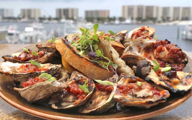 oysters rockefeller platter with harbor background at brotulas seafood house steamer destin