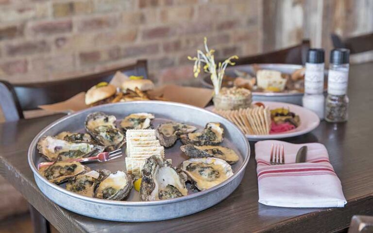 oysters tray on interior dining table setting at boshamps seafood oyster house destin