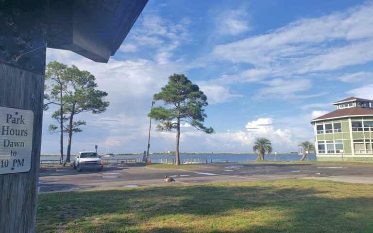 parking area with hours sign and lake at liza jackson park fort walton beach