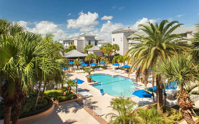 pool area with trees and hotel buildings at marriott hutchinson island beach resort golf marina stuart