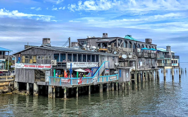 restaurant and fishing dock structure over bay water at cedar key florida