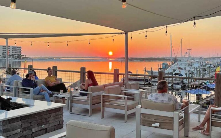 rooftop lounge area with sunset over harbor at the edge seafood restaurant skybar destin