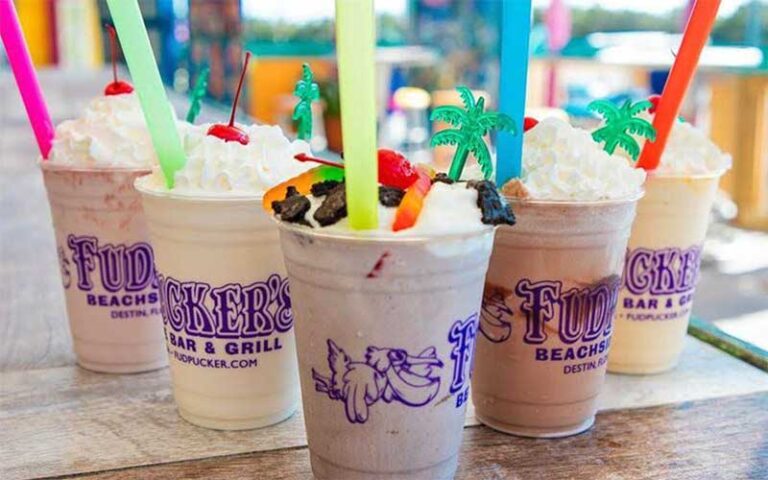 row of mudslide cocktails with big straws at fudpuckers beachside bar grill destin