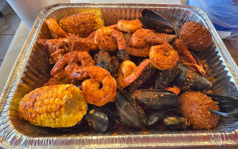 seafood boil in tray at outcast seafood miramar beach