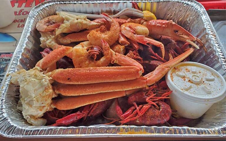seafood boil with crab legs and shrimp in tray at stewbys seafood shanty fort walton beach