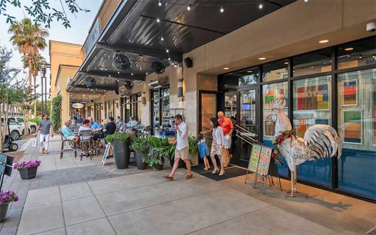shoppers with a row of stores at grand boulevard at sandestin miramar beach